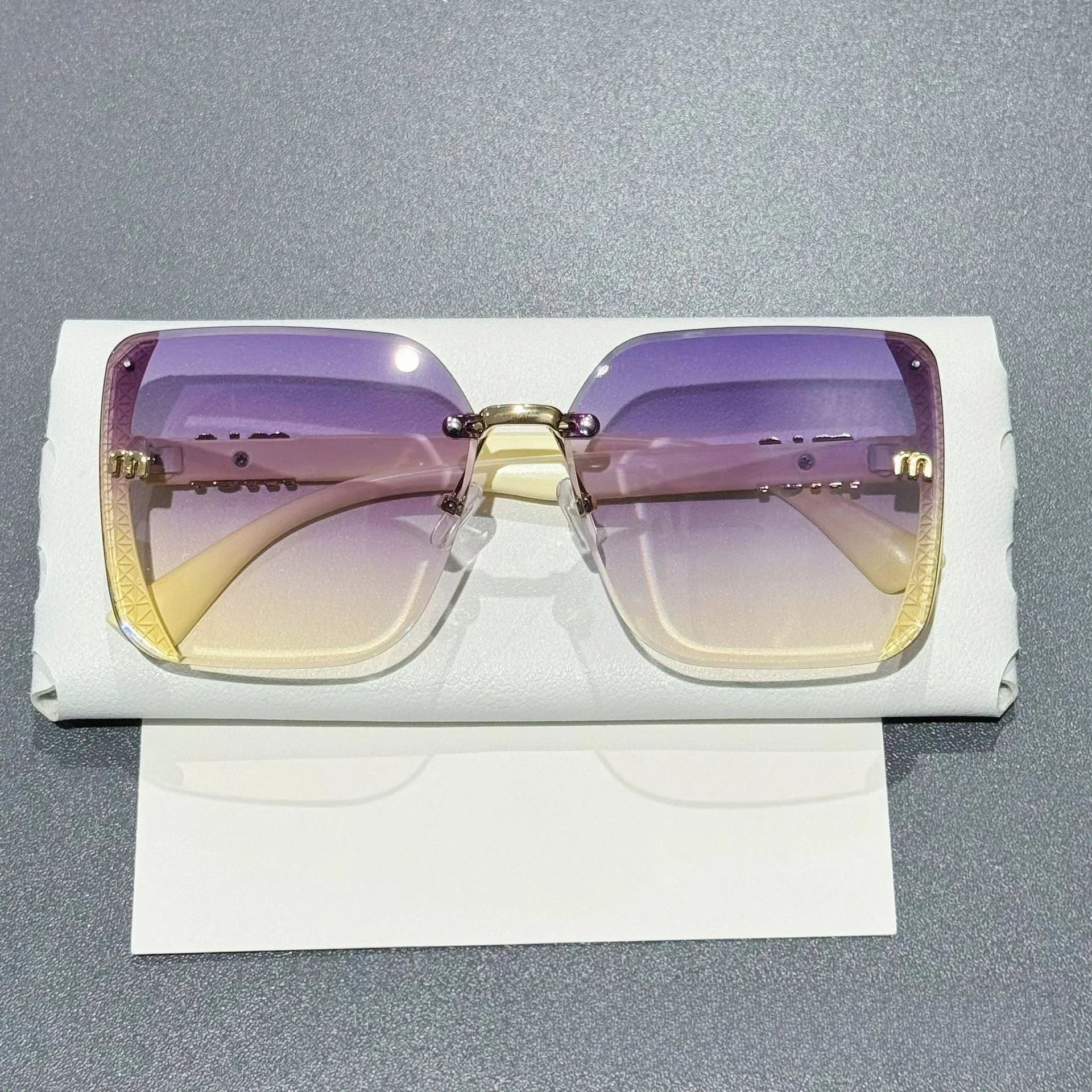 Randlose Sonnenbrille mit Farbverlauf und glitzerbesetzter Brücke